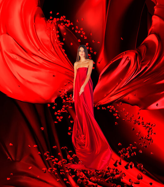Goddess of love in long red dress with magnificent long hair makes a magic ritual of connecting hearts of on red drapery, fabric