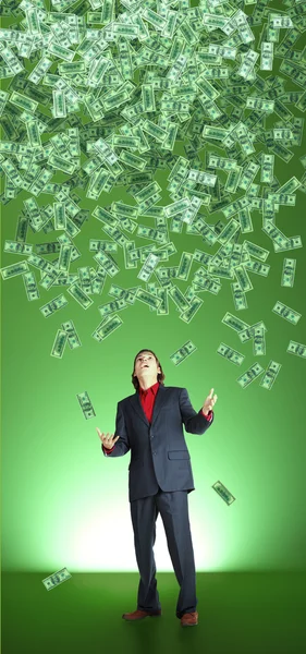 Businessman catchs flying banknotes — Stock Photo, Image