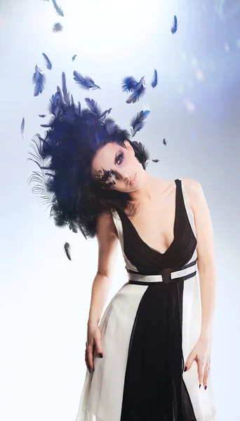 Brunette woman with magnificent hairstyle of black feathers — Stock Photo, Image