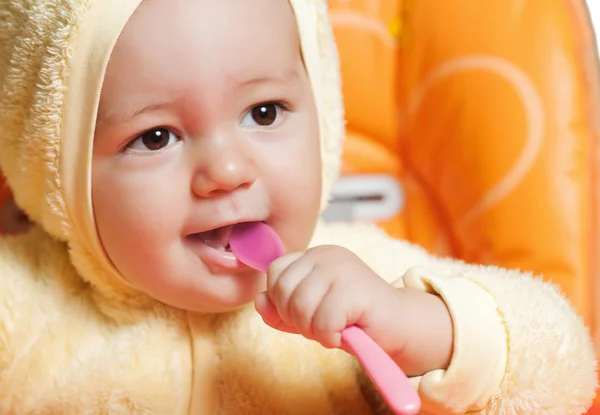 Little boy eating with spoon — Stock Photo, Image