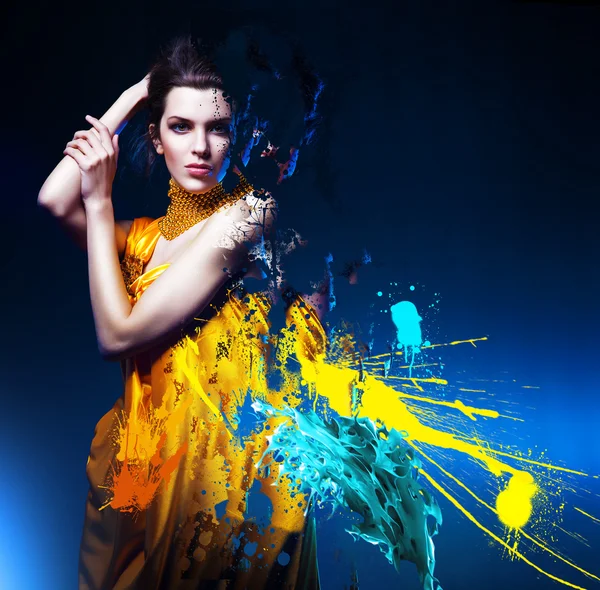 Sensual sexy woman in long yellow dress and splatter — Stock Photo, Image