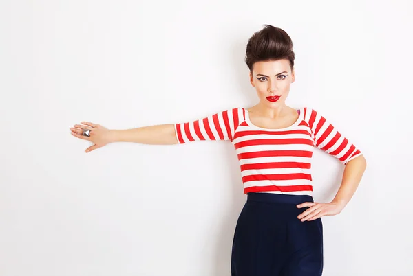 Cute brunette woman with hand on wall — Stock Photo, Image