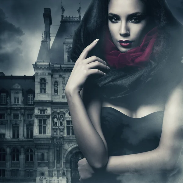 Sexy woman in black hood and castle Stock Picture