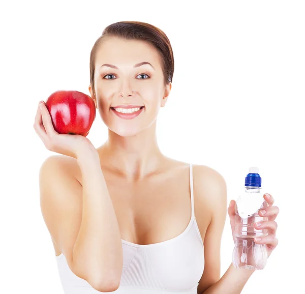 Gelukkige vrouw met fles water en rode appel — Stockfoto