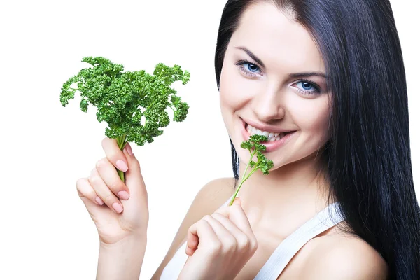 Smiling girl biting parsley Stock Photo