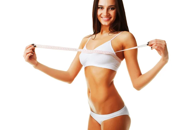 健康的运动型女人，完美的身体与白色的措施 — 图库照片