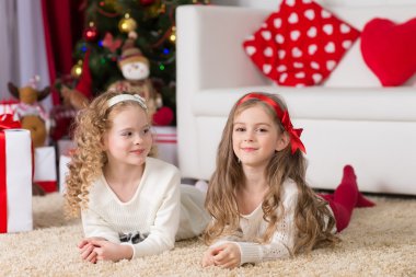 Noel, Noel, Noel, kış, mutluluk konsepti - tabletle oynayan iki sevimli kıvırcık kız