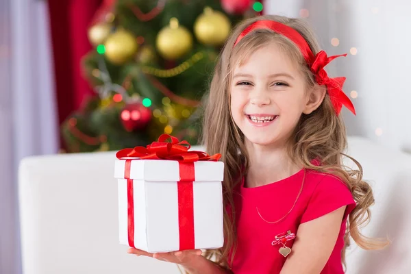 Portrait of little happy cute girl with Christmas present — Stock Photo, Image