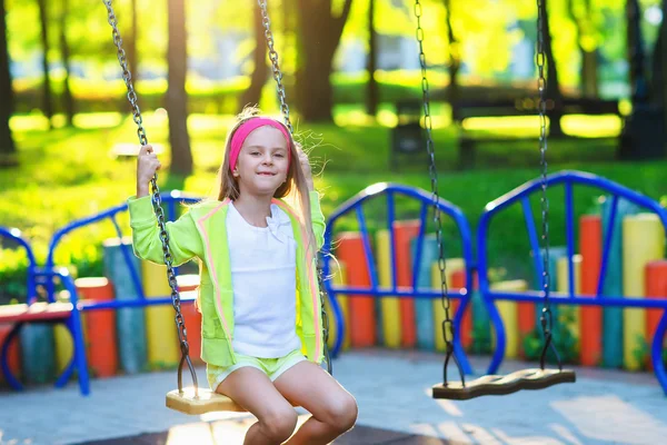 Cute girl having fun on a swing on summer day — Stock Photo, Image