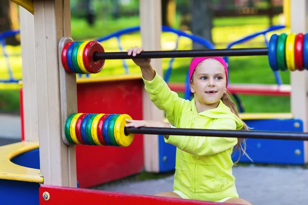 Little girl having fun at a playground — Stock Photo, Image