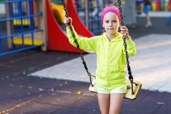 Cute girl having fun on a swing on summer day — Stock Photo, Image