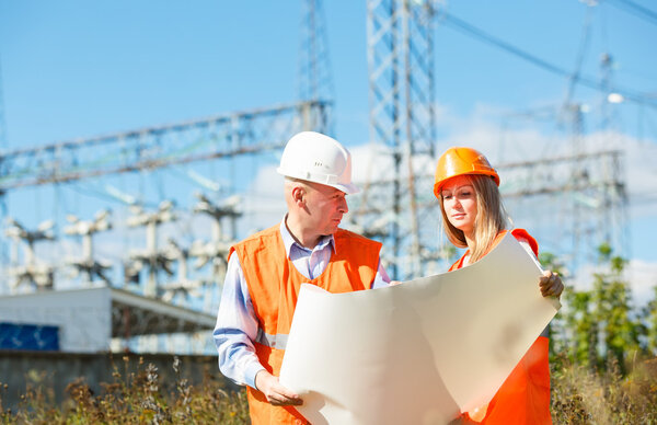 Male and female construction workers in the helmet