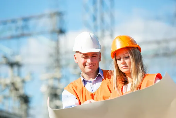 Male and female construction workers in the helmet — Stock Photo, Image