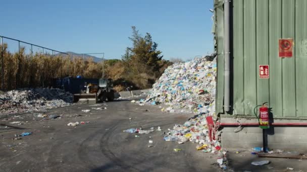 SANTA MARIA DE PALAUTORDERA, SPAIN - JANUARY 1, 2022:Waste falling on pile at recycling factory — Videoclip de stoc