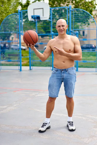 Pohledný Muž Basketbalovým Míčem Dívá Kamery — Stock fotografie