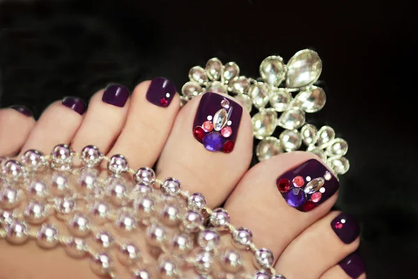 Holiday elegant purple pedicure. — Stock Photo, Image