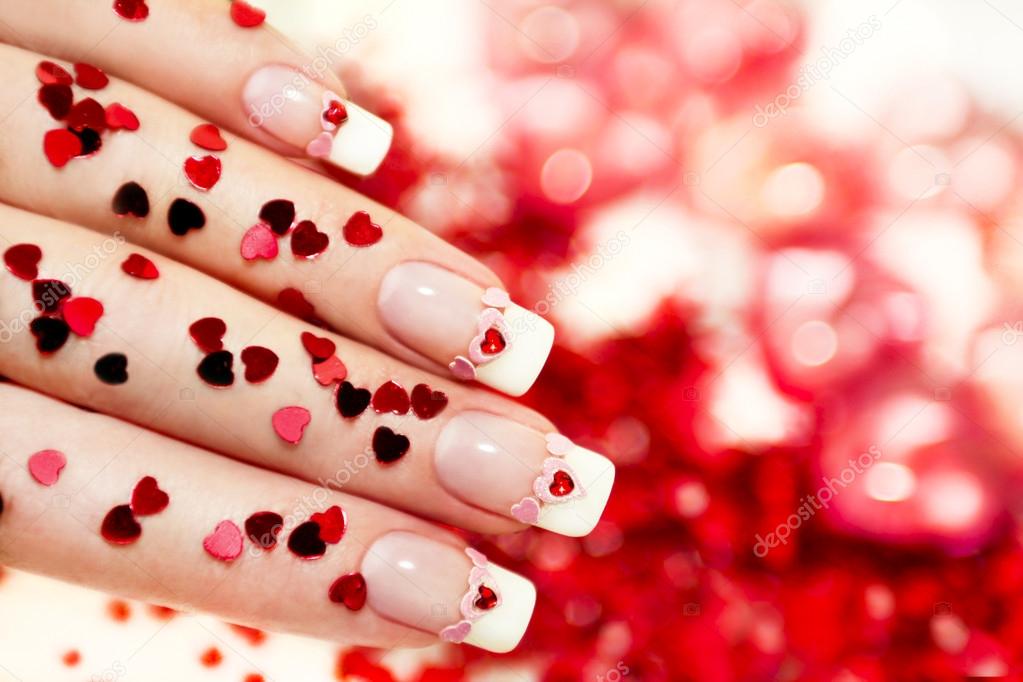 Manicure with a red heart .