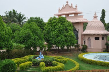 Statue of Hindu Lord Krishna at Shree Swaminarayan Gurukul in Hyderabad, India clipart