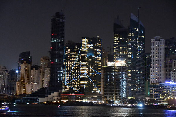 DUBAI, UAE - DEC 25: View of Dubai Marina at night, from Bluewaters Island, in Dubai, UAE, as seen on Dec 25, 2021.