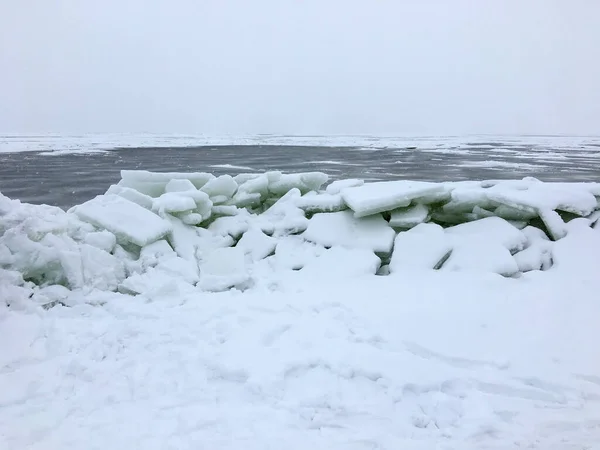 The frozen coast of the Gulf of Finland with a bizarre form of ice. Zelenogorsk, Russia, spring season, ice breaking period