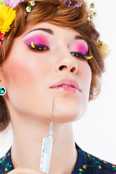 Girl with make-up and a syringe for wrinkles — Stock Photo, Image