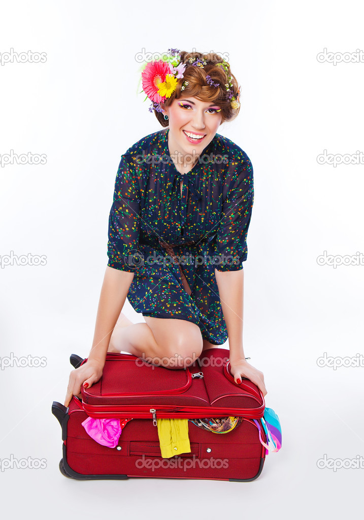 Young woman packing her suitcase