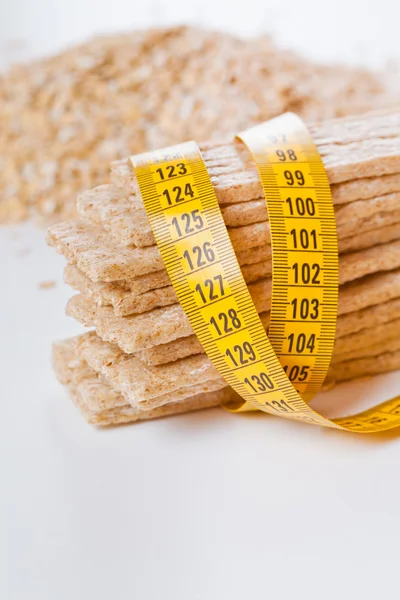 Diet flakes, bread and measuring tape — Stock Photo, Image
