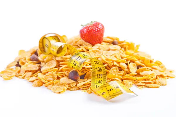 Muesli y copos con frutas y cinta métrica —  Fotos de Stock