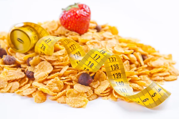 Muesli y copos con frutas y cinta métrica —  Fotos de Stock