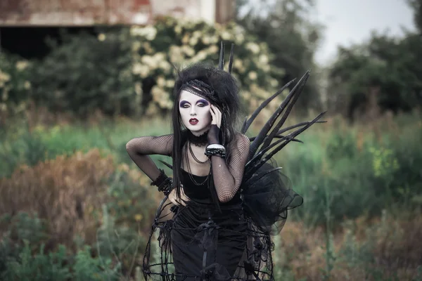 Wicked witch woman in a dark forest — Stock Photo, Image