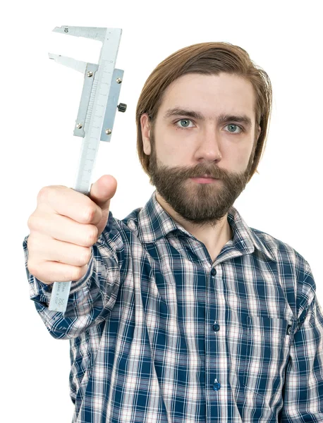 The young man with beard a holding caliper in hand — Stock Photo, Image