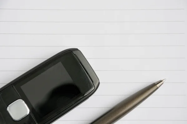 Mobile phone and a pen — Stock Photo, Image