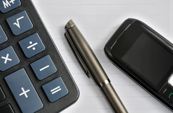 Pen, mobile phone and a calculator — Stock Photo, Image