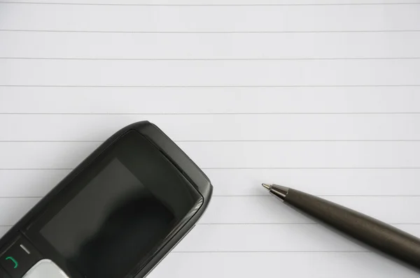 Mobile phone and a pen — Stock Photo, Image