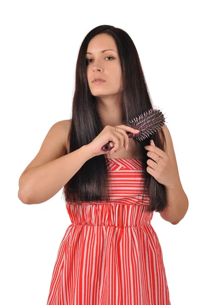 Woman combs her hair — Stock Photo, Image