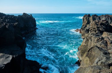 San Miguel Island, Azores, Portugal. Seascape. Black volcanic stones and the Atlantic Ocean.