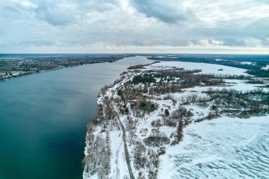 View of the dirt road near the Dnieper River in winter. Aerial photography.