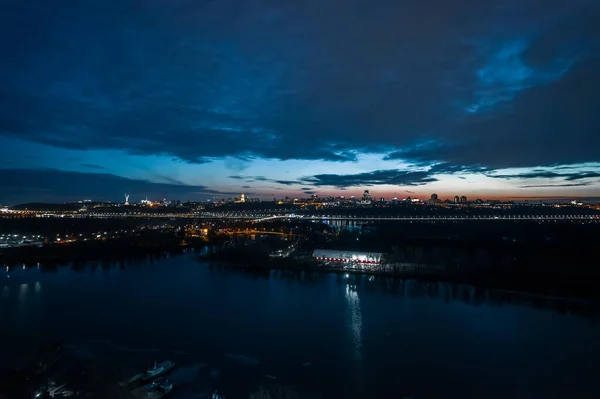 View from the left to the right bank at night in Kyiv. City landscape.