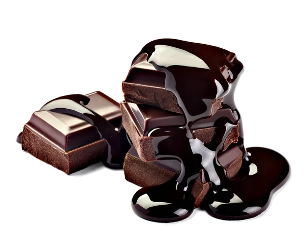 close up of chocolate pieces stack and chocolate syrup on white background
