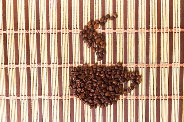 Symbol texture of coffee grains on the mat — Stock Photo, Image