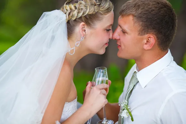 Bride and groom newlyweds at wedding couple holding glass of tou — Stock Photo, Image