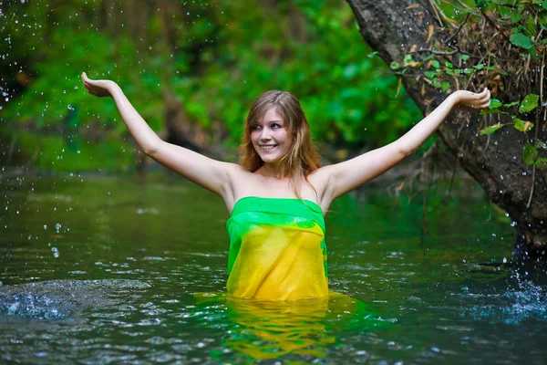 Female woman nude model standing under the rain, waist-deep in w — Stok fotoğraf