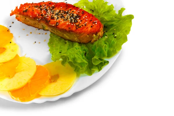 Fried fish salmon orange and apple leaf lettuce on plate isolate — Stock Photo, Image