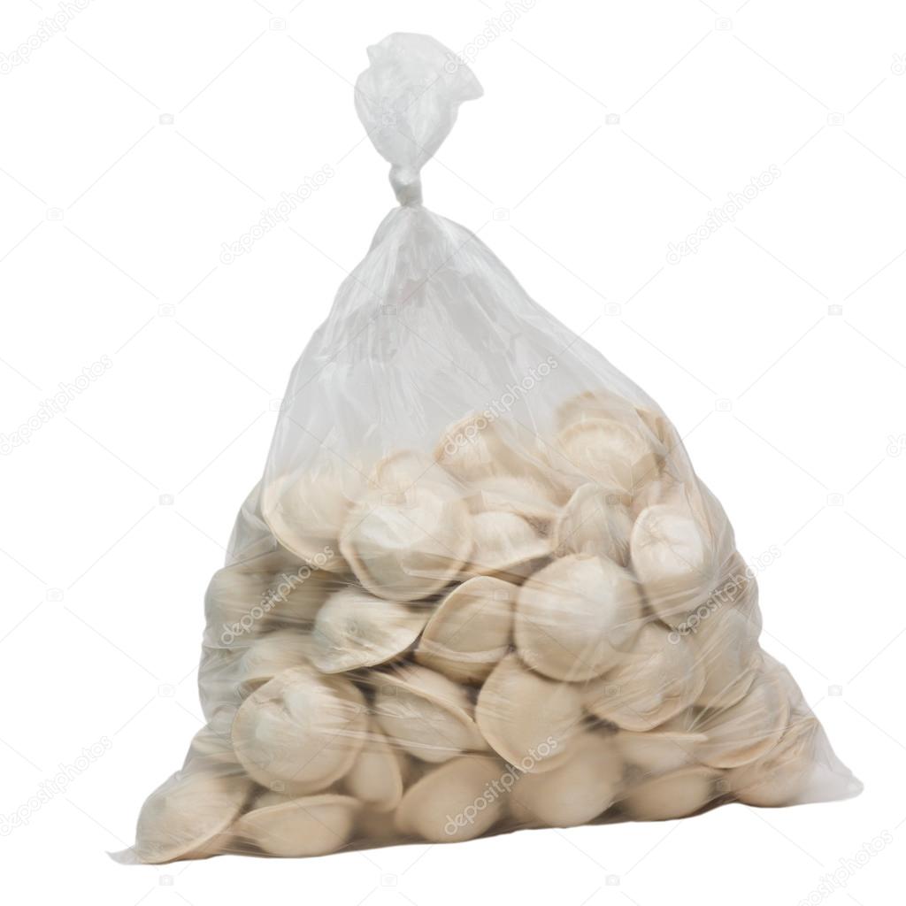 raw dumplings in a plastic cellophane bag isolated on white back