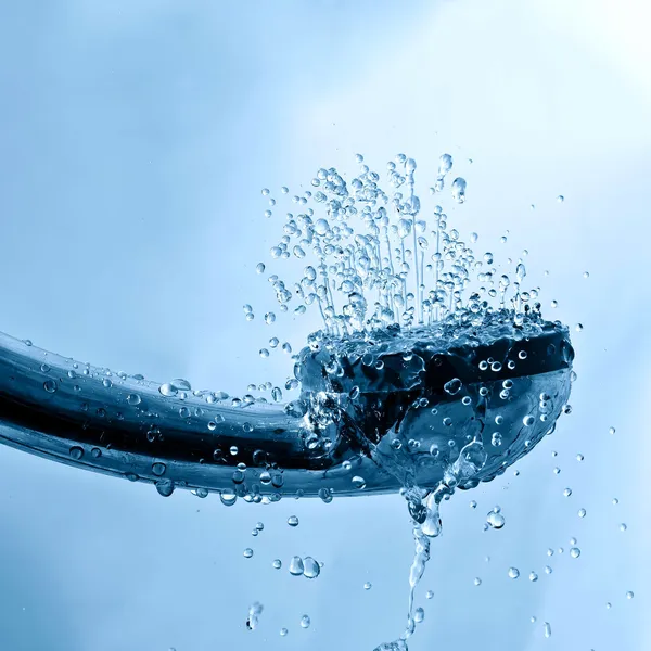 Fresh shower and drops and sprays water on a blue texture — Stock Photo, Image