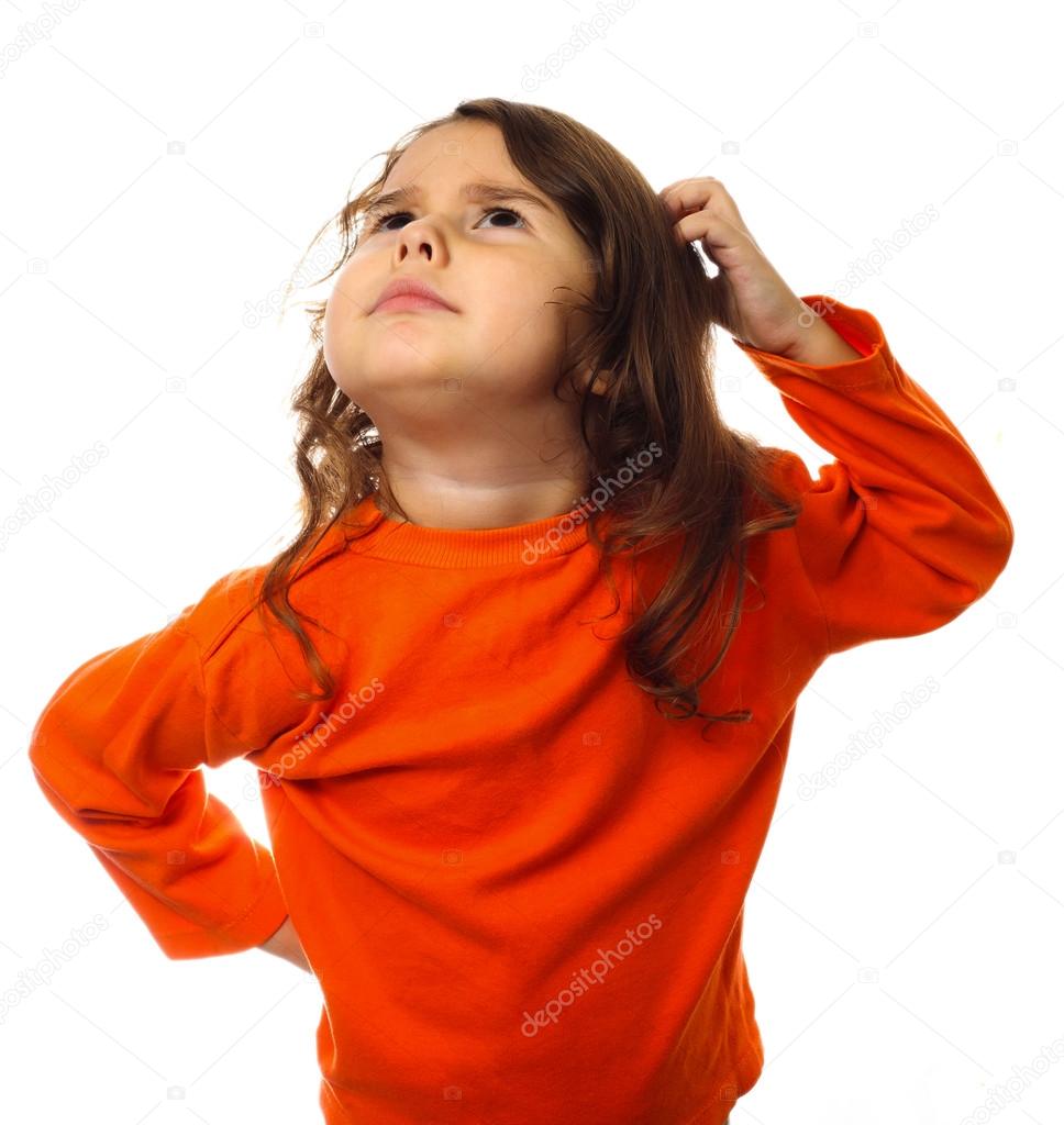 Portrait brunette kid in orange sweater, scratching his head thi