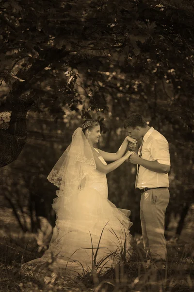 Retro sepia black and white photo bride groom kissing hand of bl — Stock Photo, Image