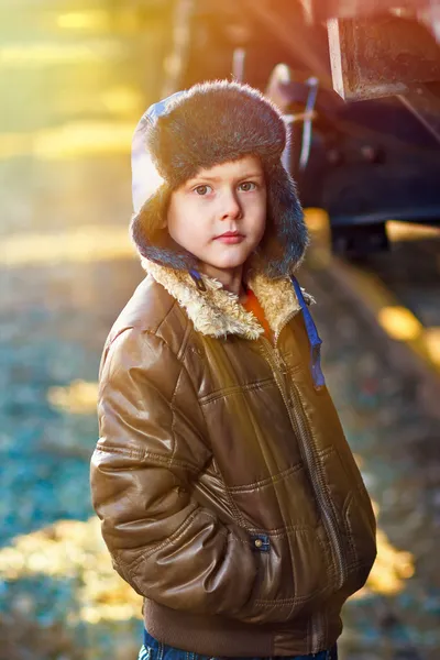 Sunlight Boy homeless bum on street freezing close to railway ca — Stock Photo, Image