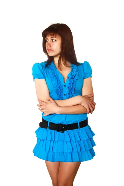 Beautiful young brunette woman in a blue dress looking to the si — Stock Photo, Image