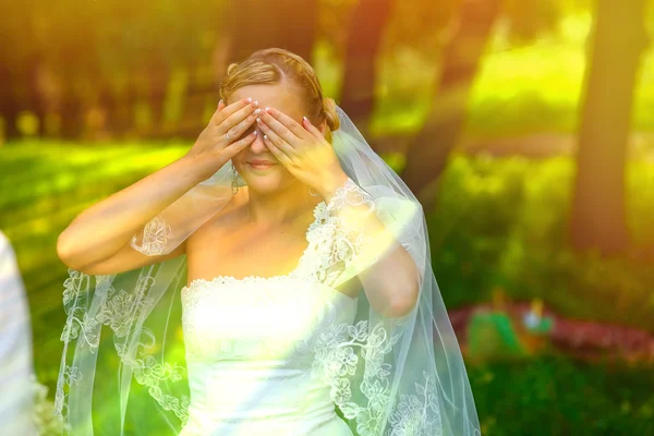 Bride sunlight woman has closed eyes with hands surprise — Stock Photo, Image